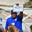 Sea aquarium Curaçao guide holding up a picture of a fish showing visitors.